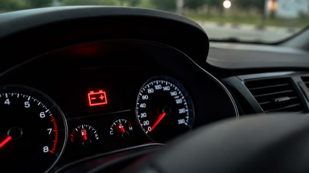 Red battery warning light illuminated on a modern car dashboard