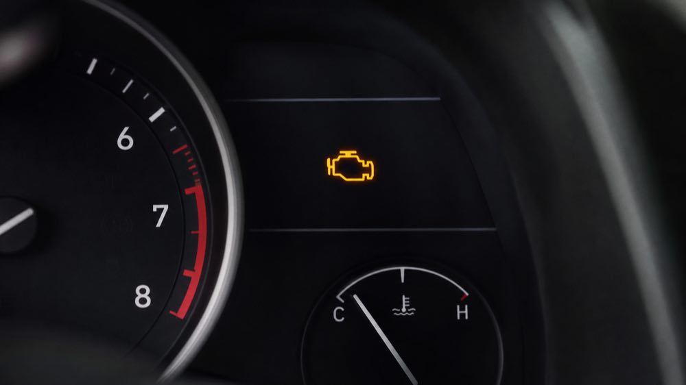 Amber check engine light illuminated on a modern car dashboard