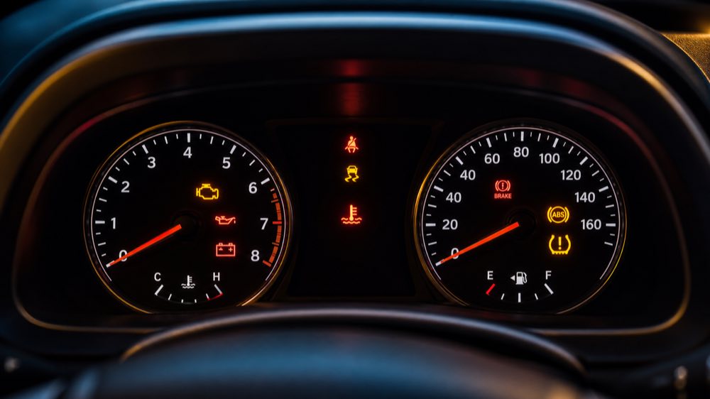 Modern car dashboard with multiple illuminated warning lights